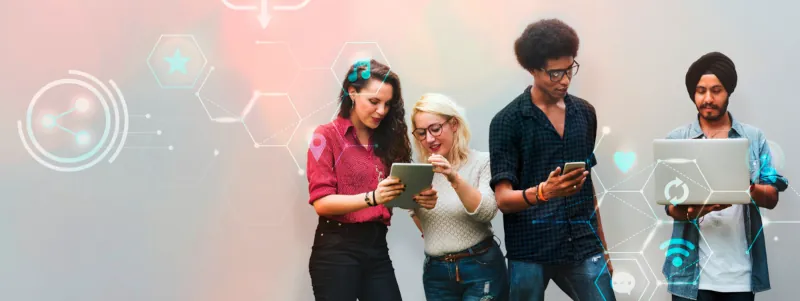 Group of people looking at different IT devices